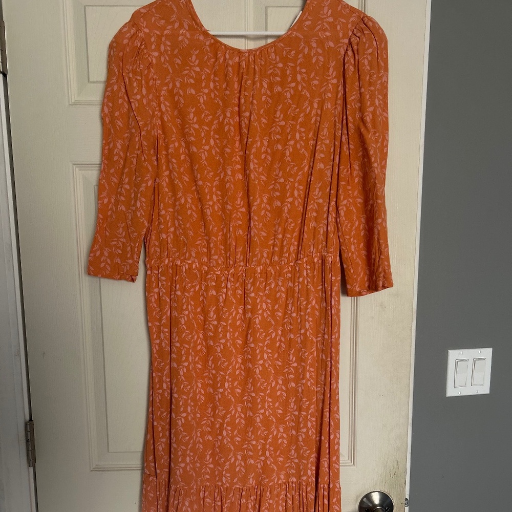 Orange dress with light pink vine flowers.